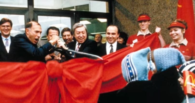 El día de la apertura del McDonald's en Moscú, el establecimiento de comida rápida fue visitado por cerca de 30.000 personas, recuerda Manu Steijaert, vicepresidente de la compañía. Fue un récord mundial en ese momento. Todos querían ser los primeros clientes de la cadena, a pesar de que el tiempo de espera de los pedidos se extendía por varias horas. Las colas empezaron a las 4.30 de la madrugada. Gorbachov durmió mal pensando en sus enemigos del Comité Central.
Pero un puñado de soviéticos hizo fila en la oscuridad para probar de una vez algo totalmente nuevo.
PUESTA DE LARGO
Para la propia compañía fue un desafío la puesta de largo. Debido a las restricciones soviéticas a las importaciones, McDonald's tuvo que construir un gran centro de procesamiento en las afueras de Moscú para producir los alimentos para su primer punto de venta en la URSS.
Pero el sitio no estaba conectado a la red eléctrica porque las autoridades soviéticas no instalaron a tiempo los cables de alimentación necesarios. Al final varios centenares de soldados soviéticos fueron desplegados para tender líneas eléctricas a la planta.
Alrededor de 27.000 soviéticos solicitaron trabajo en el primer McDonald's en Rusia, con 630 finalmente aceptados. Una de ellas era Ana Patrunina, que estuvo trabajando de cajera aquel histórico día.
Patrunina ha vivido su personal sueño americano dentro de la empresa y hoy es vicepresidenta de McDonald's en Rusia.
Ana Patrunina, cajera aquel histórico día y hoy es vicepresidenta de McDonald's en Rusia:
El día de la apertura del McDonald's en Moscú, el establecimiento de comida rápida fue visitado por cerca de 30.000 personas, recuerda Manu Steijaert, vicepresidente de la compañía. Fue un récord mundial en ese momento. Todos querían ser los primeros clientes de la cadena, a pesar de que el tiempo de espera de los pedidos se extendía por varias horas. Las colas empezaron a las 4.30 de la madrugada. Gorbachov durmió mal pensando en sus enemigos del Comité Central.
Pero un puñado de soviéticos hizo fila en la oscuridad para probar de una vez algo totalmente nuevo.
PUESTA DE LARGO
Para la propia compañía fue un desafío la puesta de largo. Debido a las restricciones soviéticas a las importaciones, McDonald's tuvo que construir un gran centro de procesamiento en las afueras de Moscú para producir los alimentos para su primer punto de venta en la URSS.
Pero el sitio no estaba conectado a la red eléctrica porque las autoridades soviéticas no instalaron a tiempo los cables de alimentación necesarios. Al final varios centenares de soldados soviéticos fueron desplegados para tender líneas eléctricas a la planta.
Alrededor de 27.000 soviéticos solicitaron trabajo en el primer McDonald's en Rusia, con 630 finalmente aceptados. Una de ellas era Ana Patrunina, que estuvo trabajando de cajera aquel histórico día.
Patrunina ha vivido su personal sueño americano dentro de la empresa y hoy es vicepresidenta de McDonald's en Rusia.
Ana Patrunina, cajera aquel histórico día y hoy es vicepresidenta de McDonald's en Rusia: