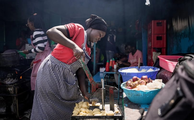 A food vendor uses a manual cutter to slice potatoes for frying at a food stall in Nakuru market, Nakuru, Kenya. (Courtesy: Kreis Visual Storytelling) A food vendor uses a manual cutter to slice potatoes for frying at a food stall in Nakuru market, Nakuru, Kenya. (Courtesy: Kreis Visual Storytelling)