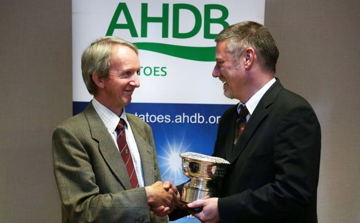 Last year's winner of the British Potato Industry Award, Jim Cruickshank, a well-known Scottish Seed Producer (left) receives the British Potato Industry Award from AHDB Potatoes Strategy Director, Rob Clayton (right) during the Seed Industry Event in St 
