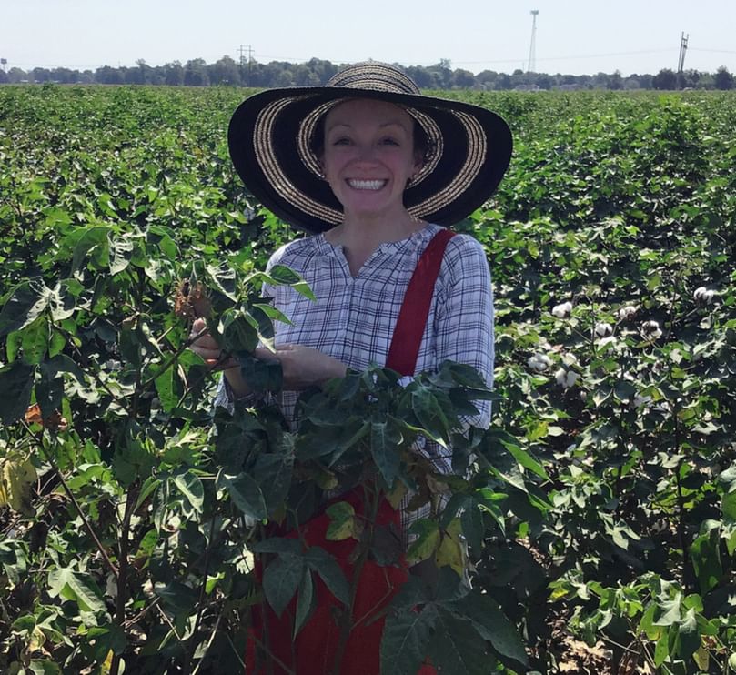 Molecular biologist Michelle Heck scouts for aphids in a cotton field. (Courtesy: Jennifer Wilson, Cornell University)