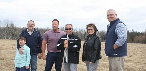 The team behind the new Taste of Maine Potato Chip Co. poses on the 30-acre property at Loring Commerce Center where they will construct a new potato chip processing plant. Pictured left to right is James Pelkey, James' son Chance Pelkey, 8, Brad Sargent,