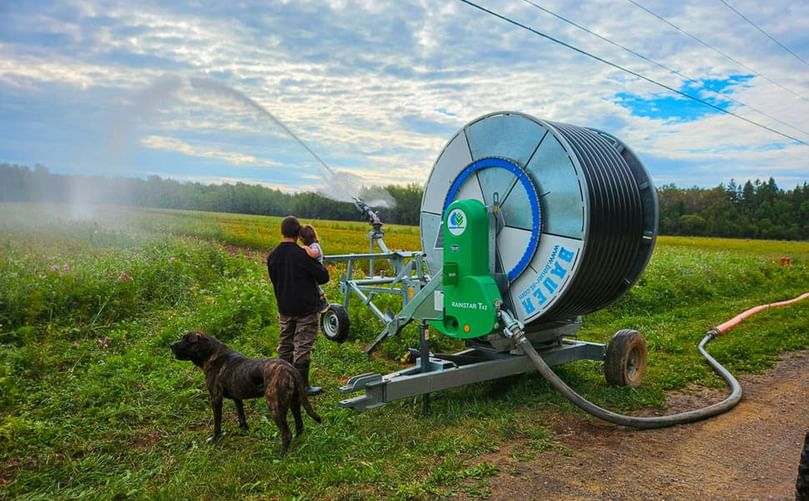 Caleb Gerritsen and daughter monitoring irrigation system Caleb Gerritsen and daughter monitoring irrigation system
