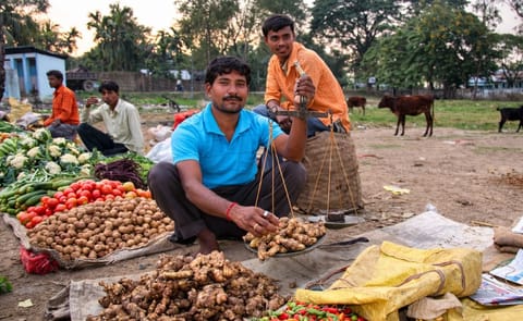 Vegetable vendor on a market in Kohora, Assam, India Vegetable vendor on a market in Kohora, Assam, India