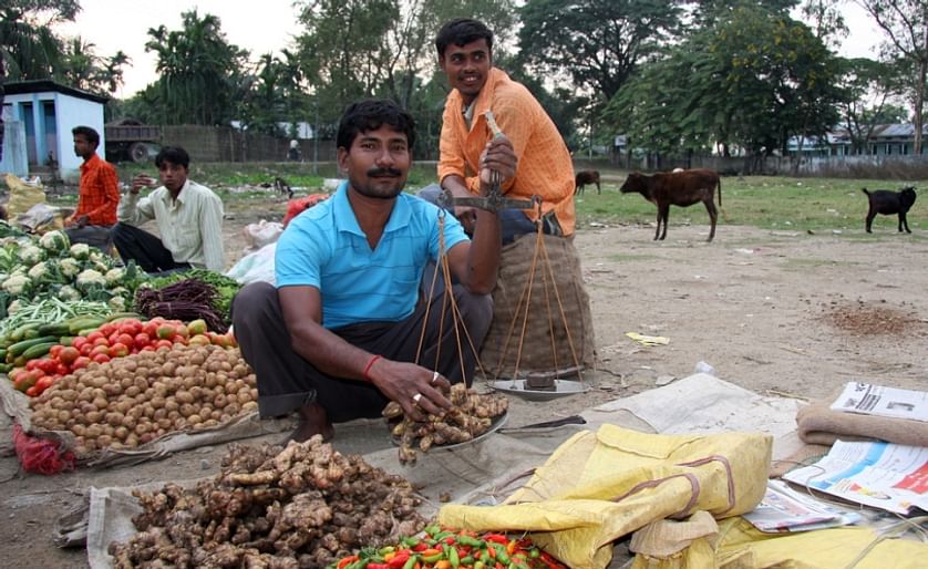 Vegetable vendor on a market in Kohora, Assam, India 