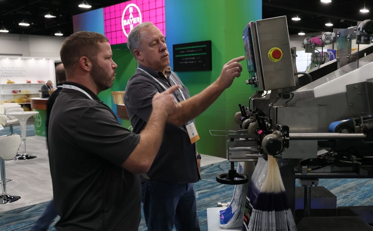 Attendees review potato packaging equipment at Potato Expo 2026 in Dallas, highlighting the latest innovations in processing and packaging technology for the global potato industry.