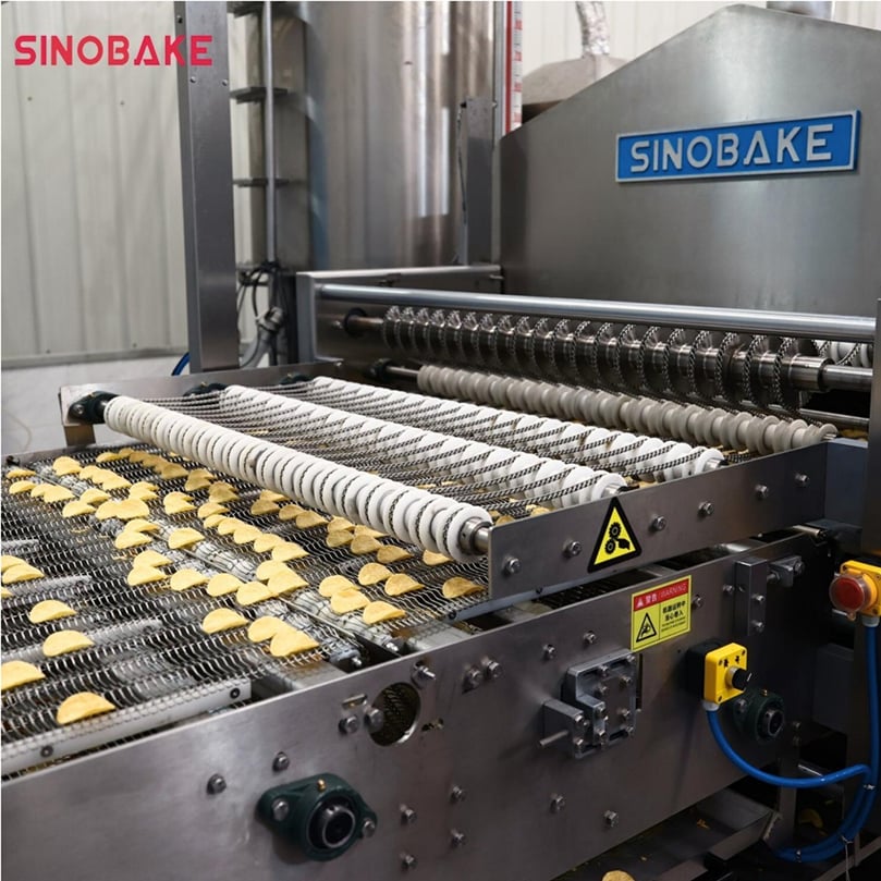 Automated conveying and frying section of the SINOBAKE stackable potato chip line, highlighting hygienic stainless-steel design and high-efficiency processing for uniform, crispy chips.