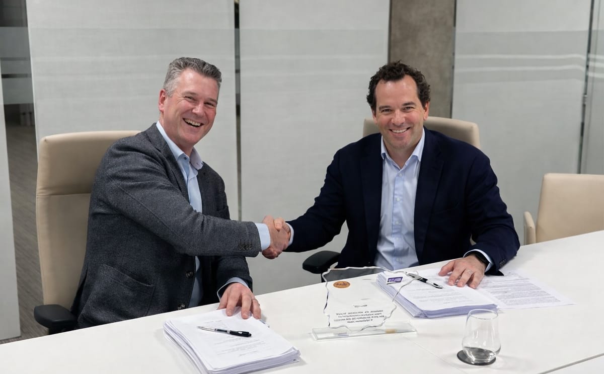 Maarten van Delst, CEO of Aviko, and Daniel de la Pedraja Yllera, Owner of Eurofrits, shake hands during the signing ceremony formalizing the acquisition agreement