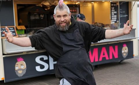 Ben Newman with his arms outstretched outside his spud trailer Ben Newman with his arms outstretched outside his spud trailer