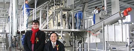 Mr André Wendt of BMA China and Mr Xu, Vice Chairman of China National Food Industry Association Potato Food Committee in front of the potato flake drum. BMA flakes line in China