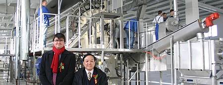 Mr André Wendt of BMA China and Mr Xu, Vice Chairman of China National Food Industry Association Potato Food Committee in front of the potato flake drum. BMA flakes line in China