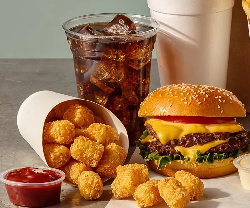 Simplot® Beef Tallow Tater Gems featured as a side with a cheeseburger meal, demonstrating their versatility across quick-service, casual dining, and foodservice applications. Simplot® Beef Tallow Tater Gems featured as a side with a cheeseburger meal, demonstrating their versatility across quick-service, casual dining, and foodservice applications.
