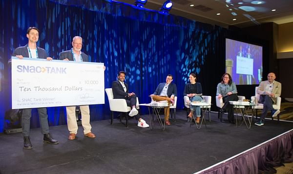 Candid snack company founder and CEO Chris Kajander receives the USD 10,000 grand prize for his pitch to SNAC Tank highlighting the sustainability of his company's Noons™ cacao bites snack