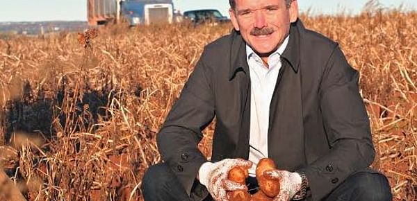 Chris Hadfield digging potatoes on Prince Edward Island