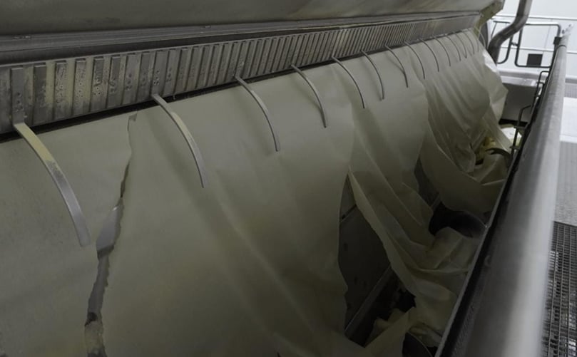 Close-up of drum drying in action, where mashed potato is transformed into uniform sheets before being milled into high-quality potato flakes.