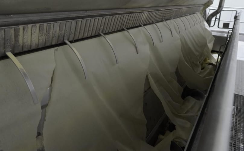 Close-up of drum drying in action, where mashed potato is transformed into uniform sheets before being milled into high-quality potato flakes.