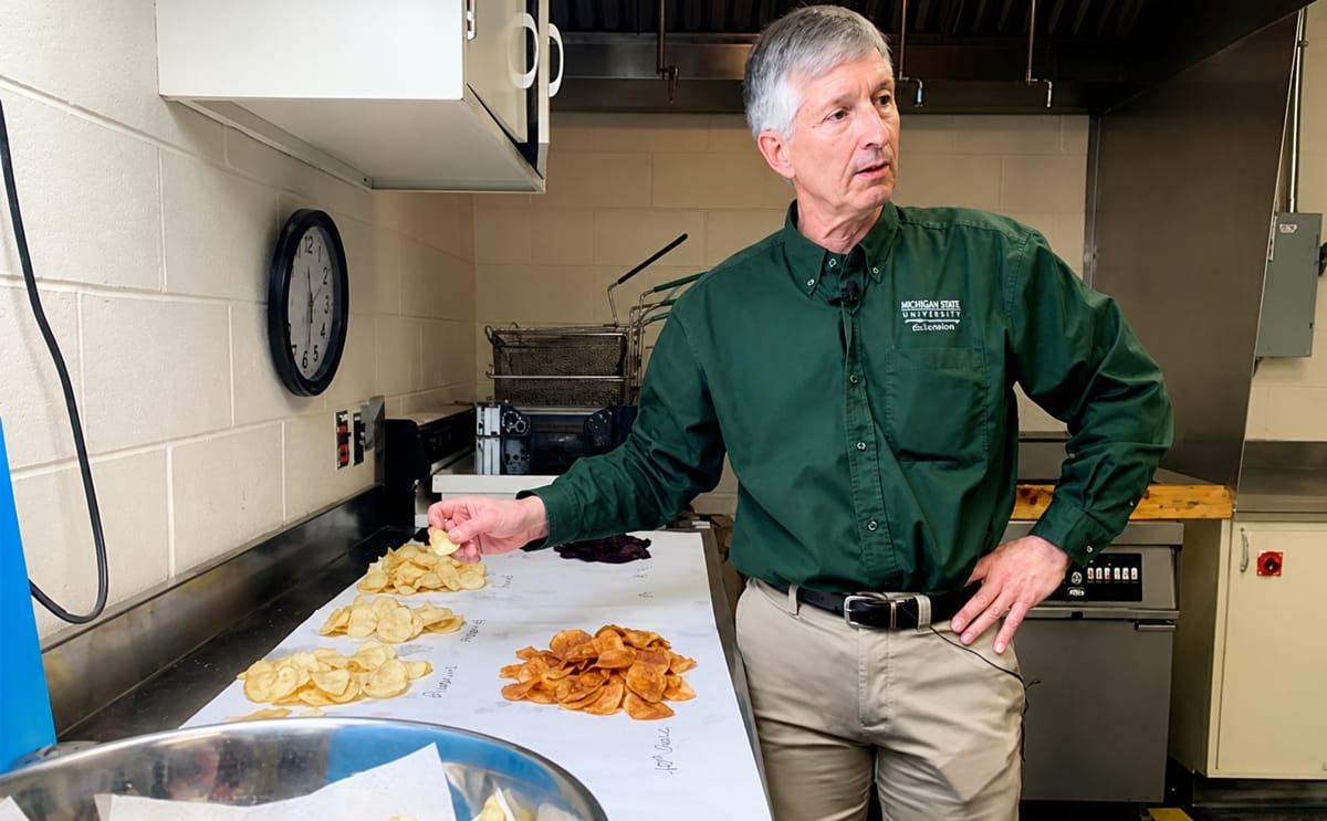 Dave Douches, director of MSU's Potato Breeding and Genetics Program, holds a potato chip in his hand during a taste testing