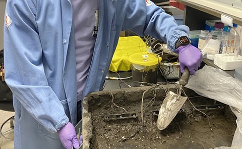 Working in the lab, Northwestern alumnus Bill Yen buries the fuel cell in soil. Working in the lab, Northwestern alumnus Bill Yen buries the fuel cell in soil.