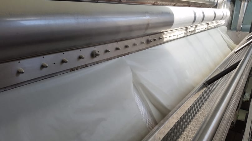 A drum dryer forms dried potato flakes from puree—an essential step in producing stackable chips using processing solutions from Tummers Food Processing Solutions.