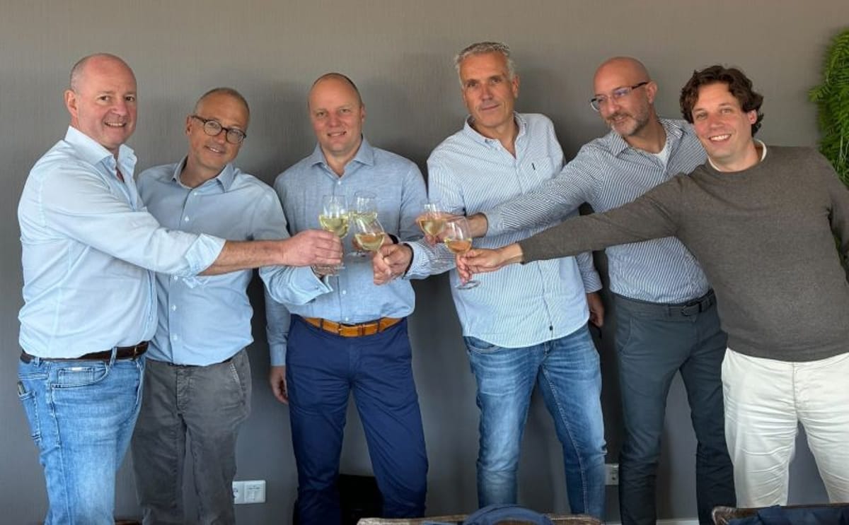 Executives from Sticomax Group and ICS Spiral Freezers celebrate the acquisition agreement, marking a new phase of growth and collaboration in global food processing solutions.