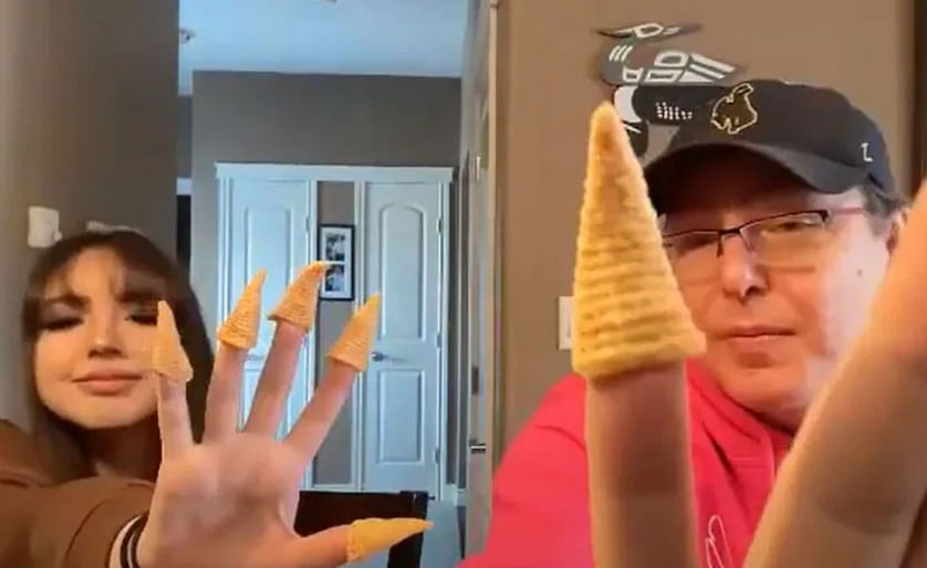 Loch Willy, right, and his daughter, Kiara, taste test a Japanese snack that's very similar to Bugles, in their Saskatoon home.