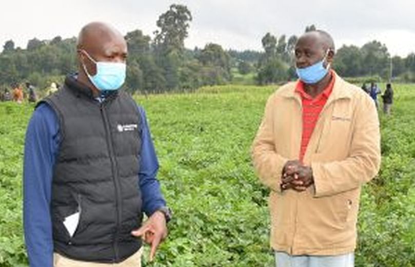 Francis Karanja, Corteva Agriscience EA Sales Leader(L) with Peter Chesum, a potato farmer, during a farmer’s field day in Ainabkoi Subcounty in Eldoret