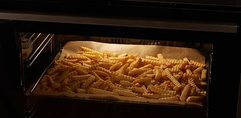 French fries on a baking tray in the oven