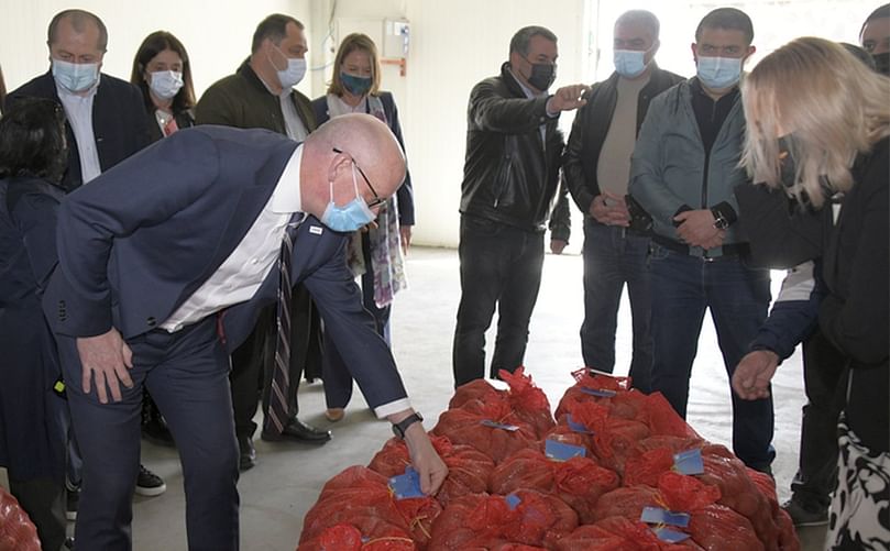 USAID's Mission Director to Georgia, Peter Wiebler (left) and Rusudan Mdviani (right), CIP's regional leader for Central Asia and Caucasus, inspect freshly-bagged potato seed at a new seed model farm in Akhalkalaki.