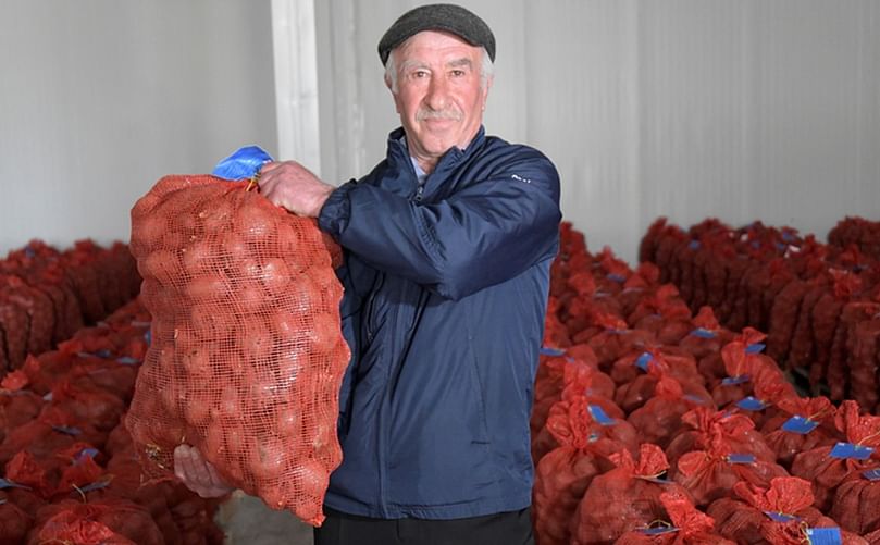 Apetenak Zandarian, a member of the Potato Producer Network in Georgia, holds a bag of disease-free potato seed cultivated at the seed model farm in Akhalkalaki. High-quality seed such as this will increase yields for potato farmers throughout Georgia. The Potato Producer Network was established within the USAID Potato Program. Apetenak Zandarian, a member of the Potato Producer Network in Georgia, holds a bag of disease-free potato seed cultivated at the seed model farm in Akhalkalaki. High-quality seed such as this will increase yields for potato farmers throughout Georgia. The Potato Producer Network was established within the USAID Potato Program.