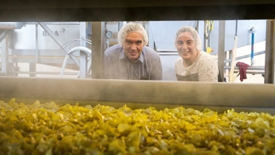Heartland Potato Chips owner Raymond Bowan and his daughter, general manager Charlotte Bowan, keep an eye on their new range of premium crafted kettle chips as they rise in the fryer. (Courtesy: Fairfax NZ)
