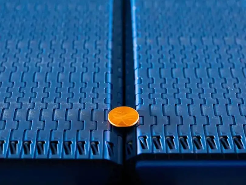 Intralox S570 Tight Transfer Belting: Reduces spoilage by 70%, prevents can stranding, and saves space with minimal transfer gaps.