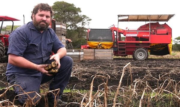 Julian Ackley risks losing his farm's profit for the year if rain doesn't clear up. 
