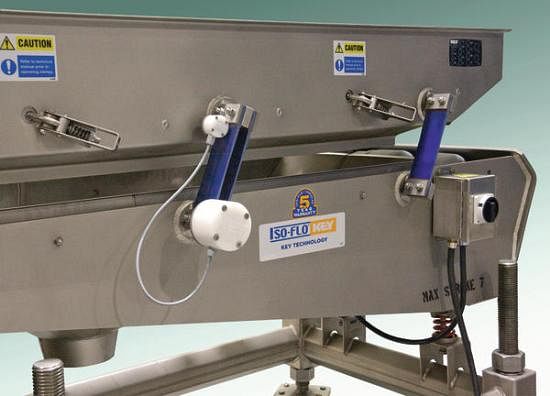 Key Technolgy's SmartArm on an Isoflo vibratory conveyor Key Technolgy's SmartArm on an Isoflo vibratory conveyor