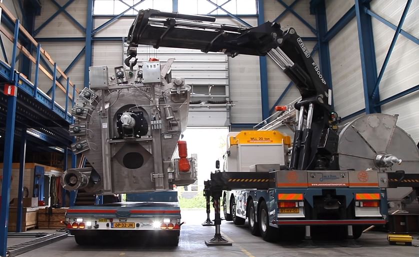 One of the four drum driers being lifted out of the production space