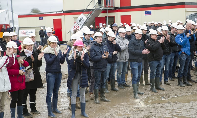 Employees & guests watch the striking of the first pile after they collectively signed it Employees & guests watch the striking of the first pile after they collectively signed it