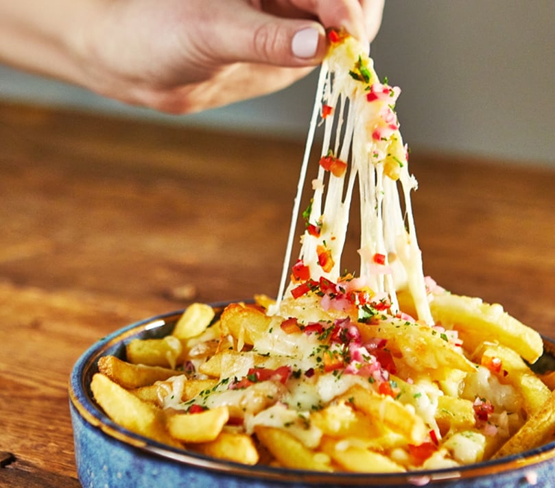 Really Crunchy Fries topped with melted cheese, highlighting the range’s suitability for premium loaded fry dishes