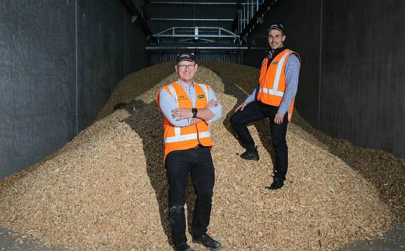 Lenard Smythe, left, and Jordan Jurcina pictured with the pile of woodchips at McCain’s Timaru factory which will be used to power their boilers from next week.