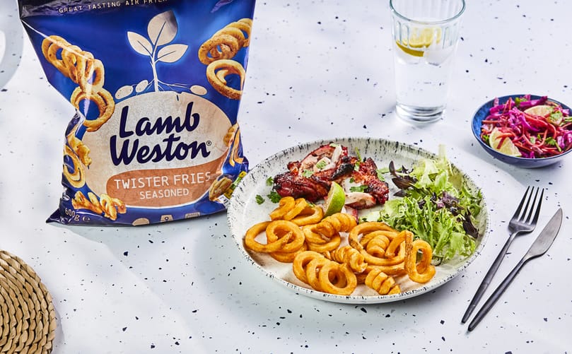 Lamb Weston Twister Fries (Seasoned) served with Asian-style chicken, demonstrating the versatility of the Product of the Year 2026 Fries range Lamb Weston Twister Fries (Seasoned) served with Asian-style chicken, demonstrating the versatility of the Product of the Year 2026 Fries range