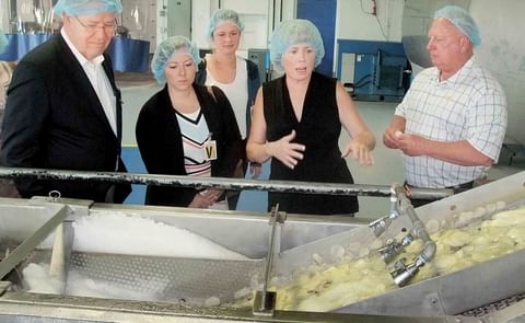 From left, West Virginia Commerce Secretary Ed Gaunch, Wood County Economic Development Executive Director Lindsey Piersol and economic development specialist Kate Barker with Wood County Economic Development watch as potato slices are rinsed during the c From left, West Virginia Commerce Secretary Ed Gaunch, Wood County Economic Development Executive Director Lindsey Piersol and economic development specialist Kate Barker with Wood County Economic Development watch as potato slices are rinsed during the c
