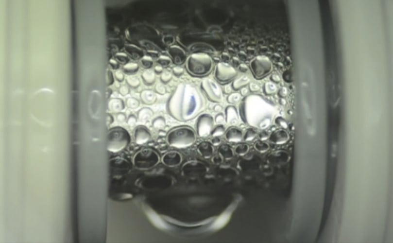 Specialized thin coatings developed by the MIT team cause even low-surface-tension fluids to readily form droplets on the surface of a pipe, as seen here, which improves the efficiency of heat transfer. (Courtesy: MIT News) Specialized thin coatings developed by the MIT team cause even low-surface-tension fluids to readily form droplets on the surface of a pipe, as seen here, which improves the efficiency of heat transfer. (Courtesy: MIT News)