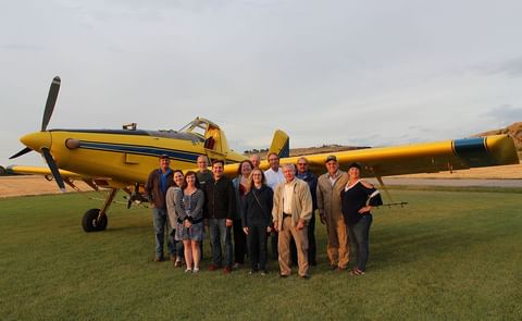 During an aerial pesticide application demonstration at Hoff Farm, pilot Leif Isaacson (second from right) conducted fly-overs to show participants the capabilities of the spray plane. EPA staffers learned how the spray can be carefully controlled so that During an aerial pesticide application demonstration at Hoff Farm, pilot Leif Isaacson (second from right) conducted fly-overs to show participants the capabilities of the spray plane. EPA staffers learned how the spray can be carefully controlled so that