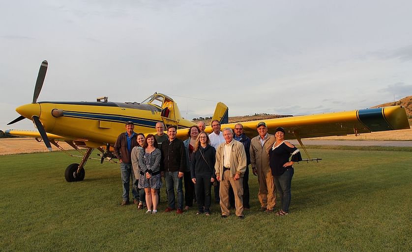 During an aerial pesticide application demonstration at Hoff Farm, pilot Leif Isaacson (second from right) conducted fly-overs to show participants the capabilities of the spray plane. EPA staffers learned how the spray can be carefully controlled so that