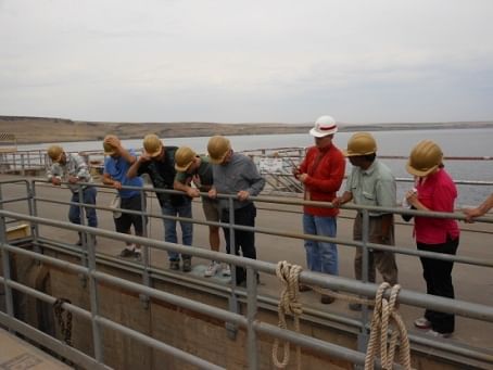 Tour participants peered down from the top of the McNary Dam on the Columbia River, which drives giant turbines that generates enough hydroelectric energy to power more than 600,000 area homes. Tim Roberts, the Chief of Maintenance at the dam, emphasized the need to harness the power of the river while protecting the runs of salmon and other fish that swim up and downstream.