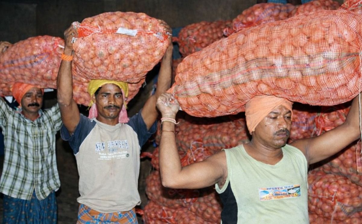 Workers carry potatoes inside a cold storage at Aiginia in Bhubaneswar, Odisha (Courtesy: Telegraph India / Ashwinee Pati)