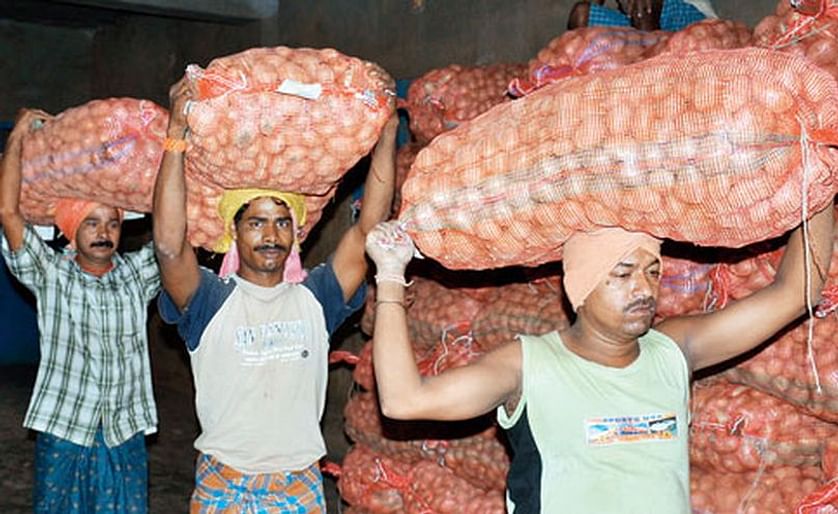 Workers carry potatoes inside a cold storage at Aiginia in Bhubaneswar, Odisha (Courtesy: Telegraph India / Ashwinee Pati)