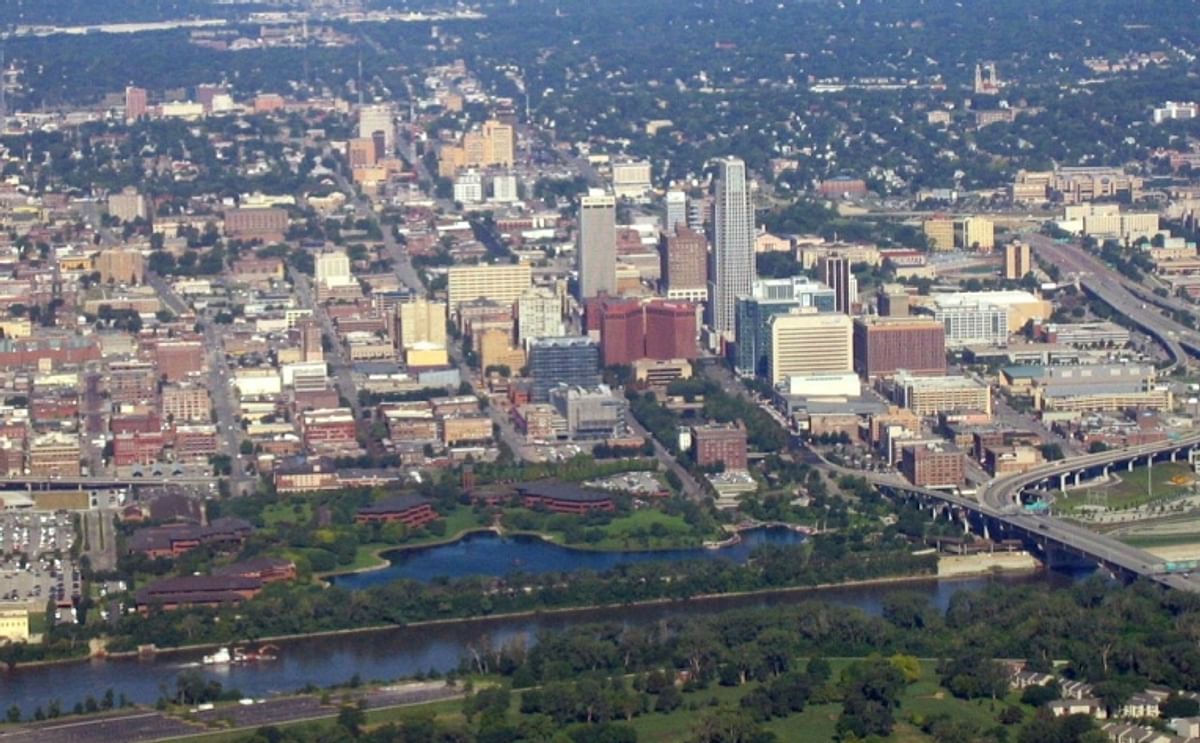 An aerial view of Omaha, Nebraska, with the Conagra Foods facilities clearly visible in the foreground around "Conagra Lake", right adjacent to the Missouri River. About 1,200 people will remain working on this riverfront campus after the restructuring is