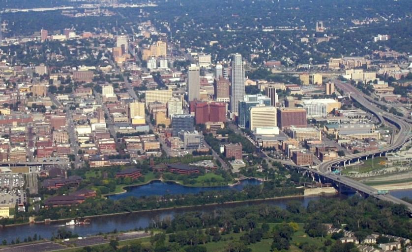 An aerial view of Omaha, Nebraska, with the Conagra Foods facilities clearly visible in the foreground around "Conagra Lake", right adjacent to the Missouri River. About 1,200 people will remain working on this riverfront campus after the restructuring is