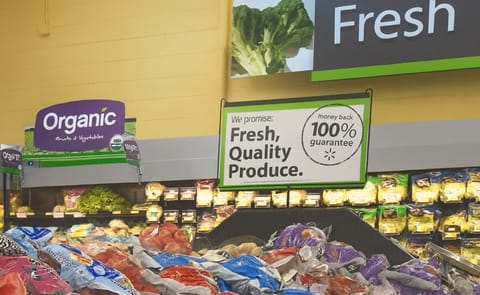 Sign promoting certified USDA Organic Fruits and Vegetables in a Walmart Produce department Sign promoting certified USDA Organic Fruits and Vegetables in a Walmart Produce department