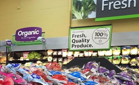 Sign promoting certified USDA Organic Fruits and Vegetables in a Walmart Produce department Sign promoting certified USDA Organic Fruits and Vegetables in a Walmart Produce department