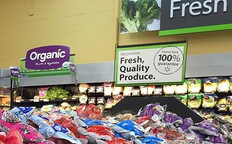 Sign promoting certified USDA Organic Fruits and Vegetables in a Walmart Produce department