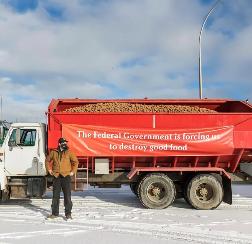 PEI Farmer stands in front of his potato truck with a message for the Federal government, during a protest in Charlottetown in 2022. Courtesy: CNW Group/PEI Potato Board< PEI Farmer stands in front of his potato truck with a message for the Federal government, during a protest in Charlottetown in 2022. Courtesy: CNW Group/PEI Potato Board<
